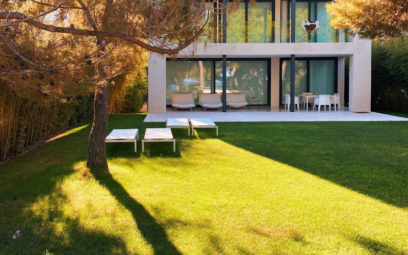 Close-up of a stainless steel micro-mesh gutter guard installed on an aluminum gutter with dried pine needles resting on the mesh surface