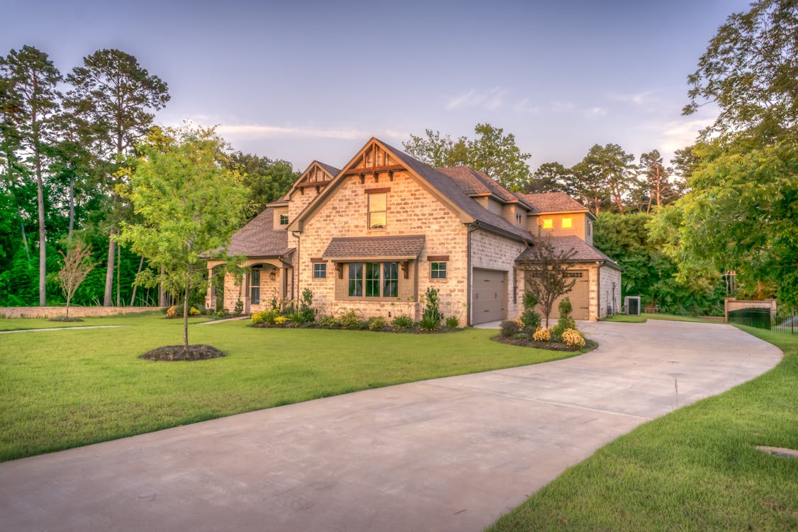 Residential home with landscaped yard and proper drainage grading away from foundation